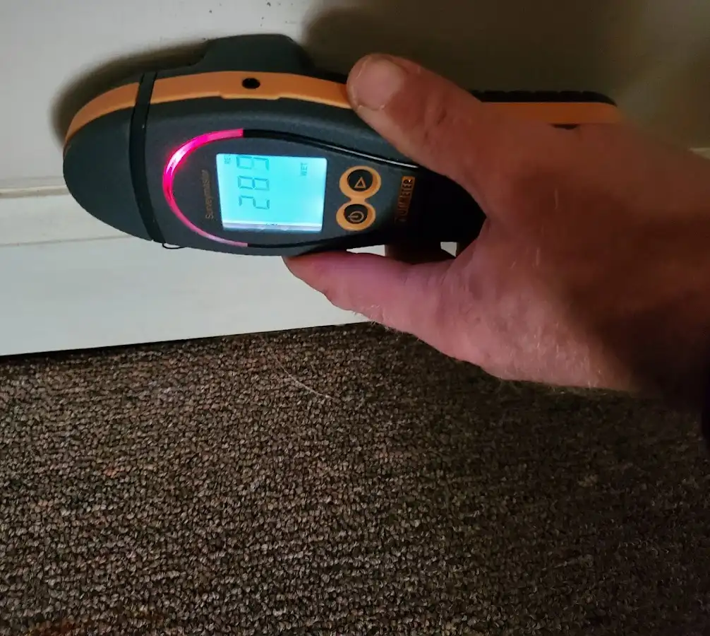 Moisture detection at baseboard during Storm Damage Restoration in Kayenta